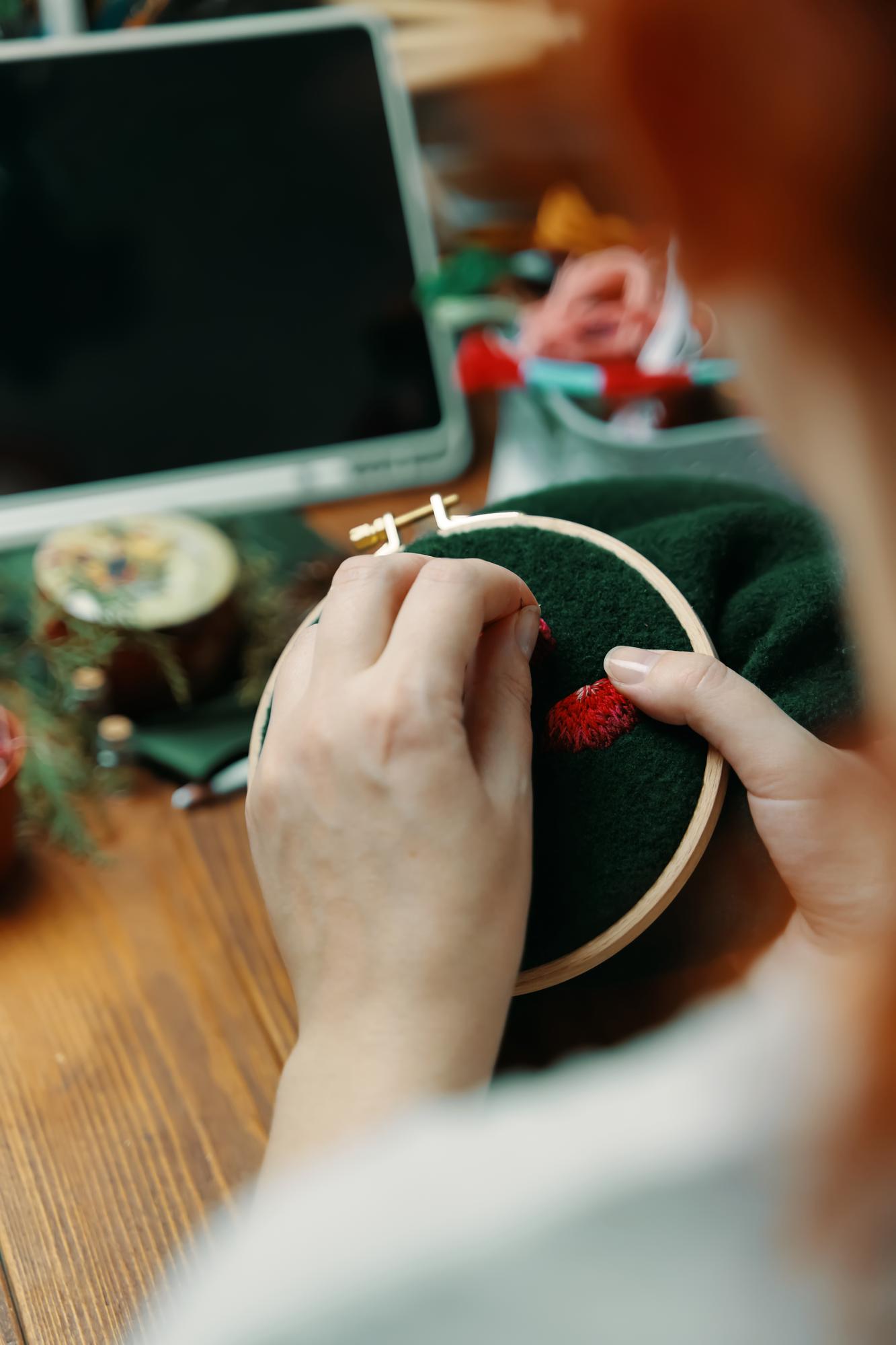 embroiderer at work with hoop